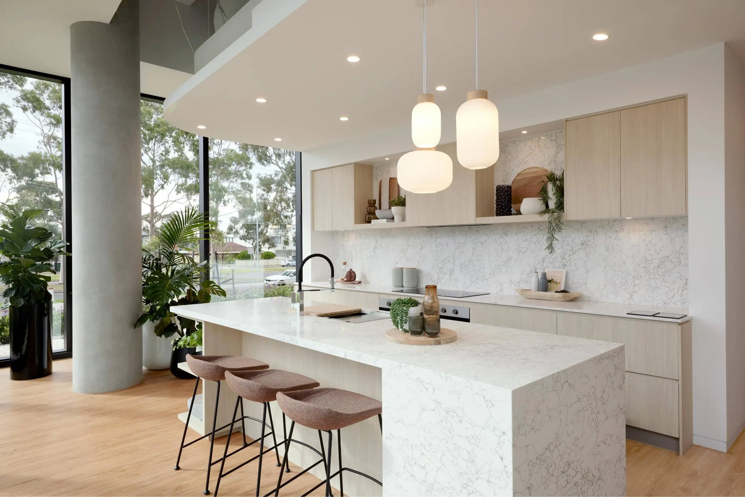 kitchen space with floor to ceiling glass and range of indoor plants