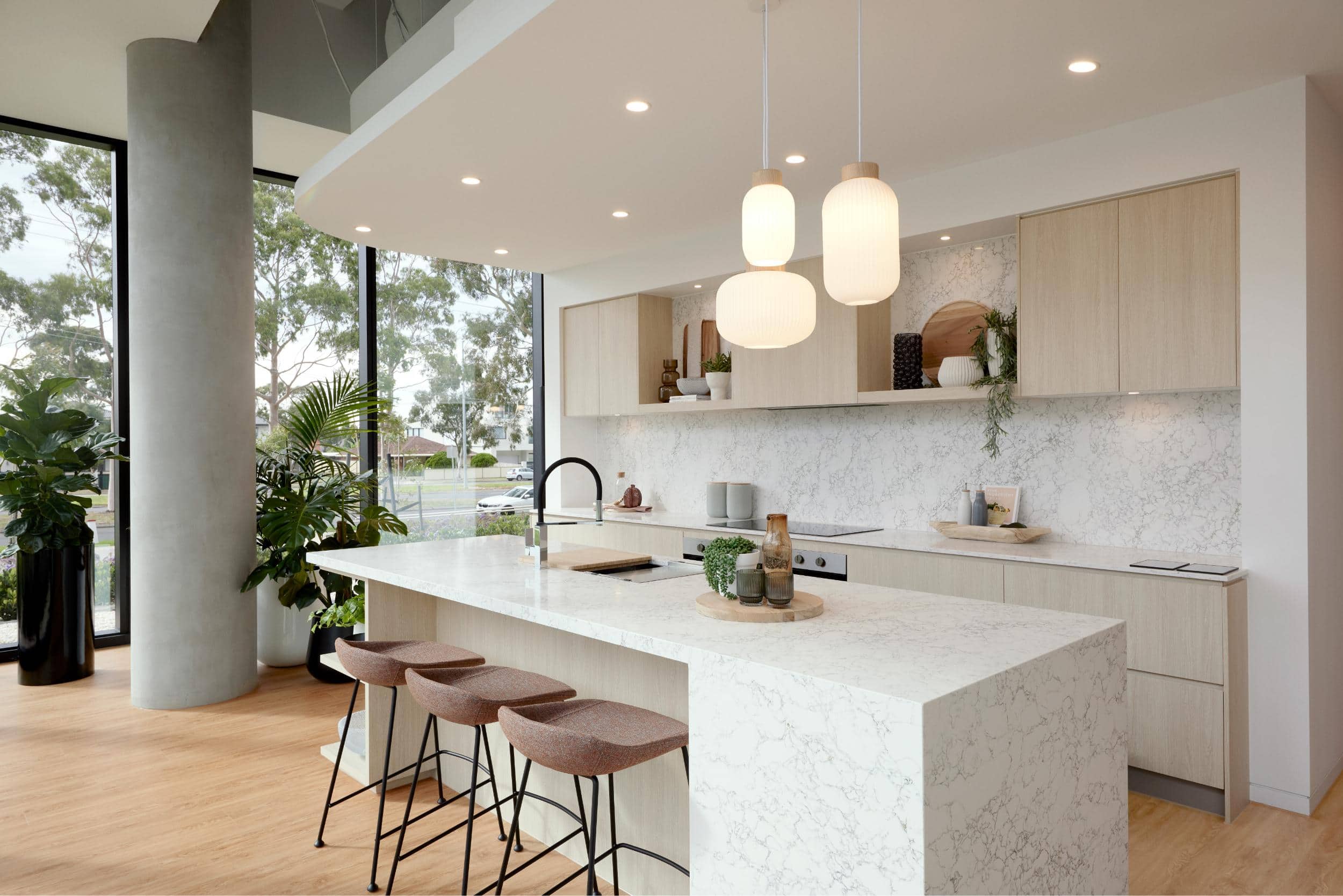 kitchen space with floor to ceiling glass and range of indoor plants