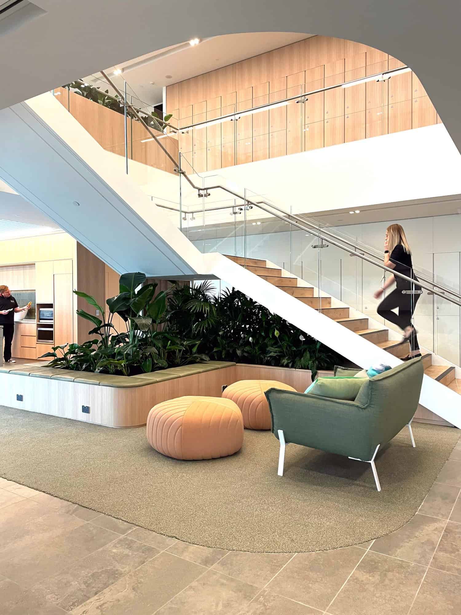 Wooden staircase in a corporate environment with plants underneath